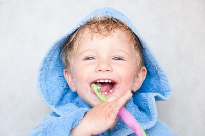 Baby with toothbrush l dentist decatur il