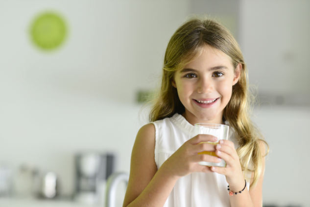 young girl smiling brightly with toothbrush I children's dentistry decatur il 