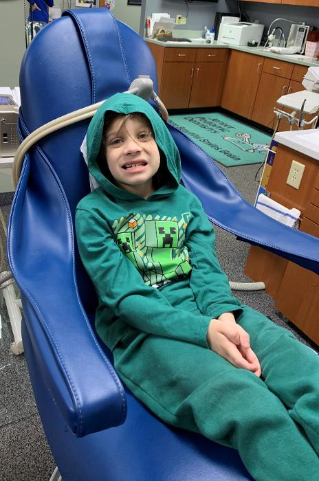 Kid relaxing during the 21st Annual Give Kids Smile event in Decatur, IL