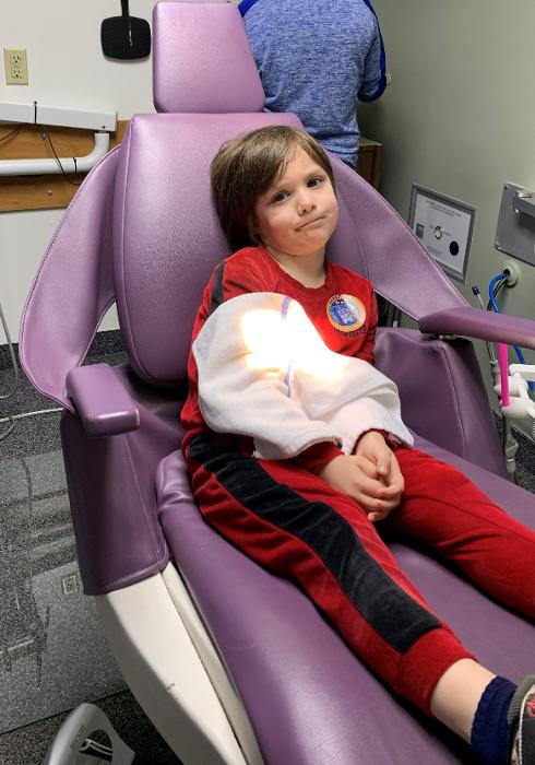 Kid relaxing during the 21st Annual Give Kids Smile event in Decatur, IL