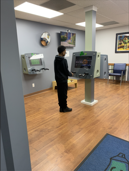 Kid observing his teeth on a machine during dental check up in Decatur, IL