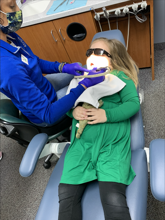 Kid undergoing dental examination and cleaning in Decatur, IL