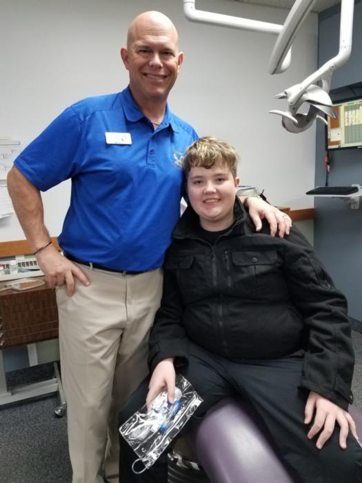 Dentist pose with a kid after dental treatment at Jerger Pediatric Dentistry