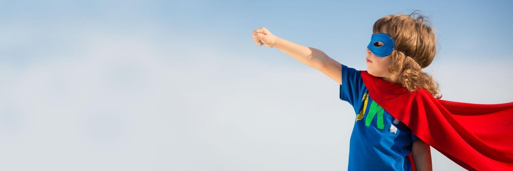 Young boy with superhero cape l Jerger Pediatric Dentistry Decatur, IL