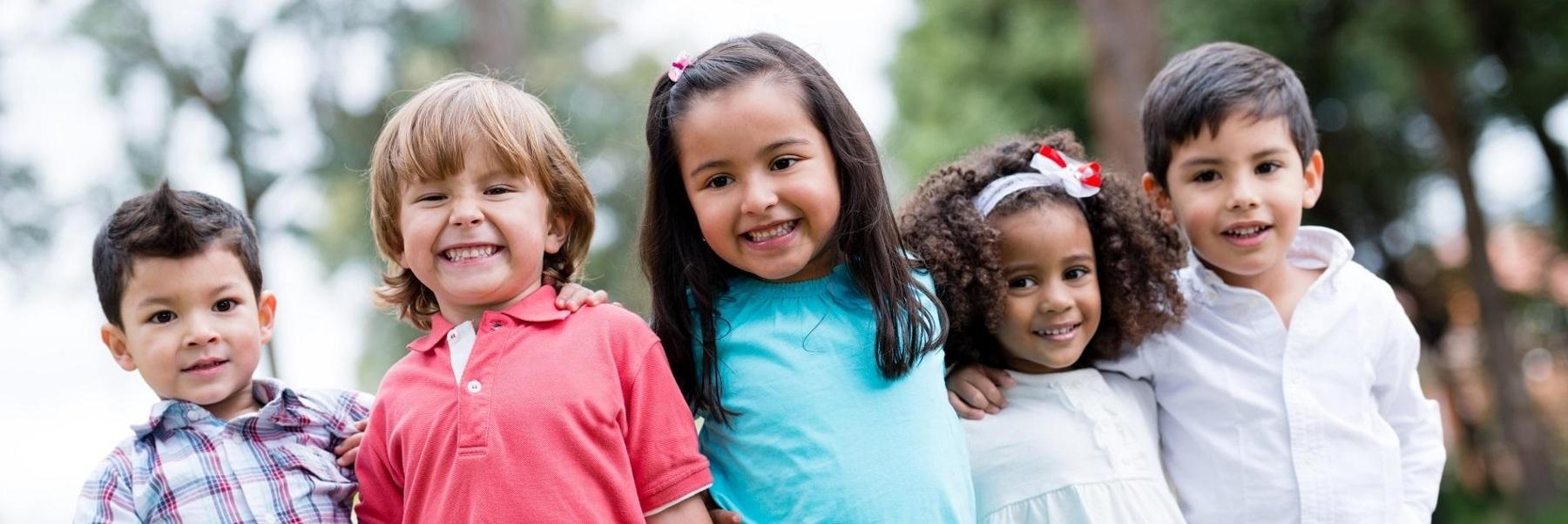 Group of five kids smiling outside after dental check up in Decatur, IL