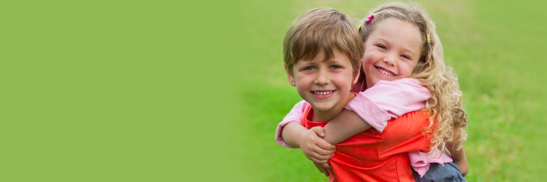 Young boy & girl smiling & hugging l Jerger Pediatric Dentistry Decatur IL