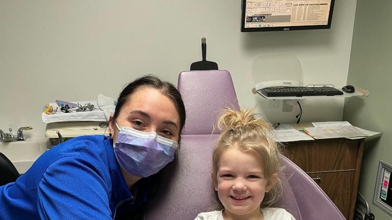 Staff smiling with patient after check up at Jerger Pediatric Dentistry