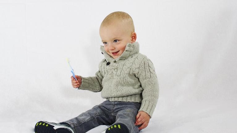 Child sitting with a toothbrush in Decatur, IL