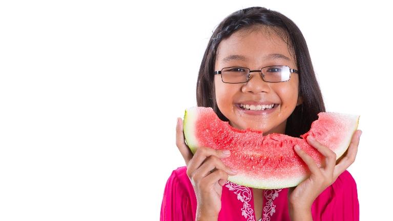 Girl eating water melon in Decatur, IL