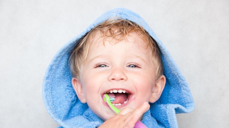 Kid playing with a toothbrush in Decatur, IL