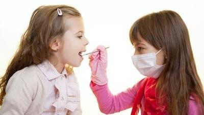 Young girls playing dentist in Decatur, IL