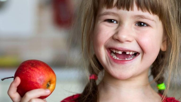 A child smiling after teeth extraction at Jerger Pediatric dentistry