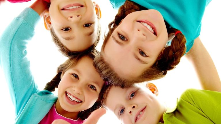 Group of four children smiling after dental check up in Decatur, IL