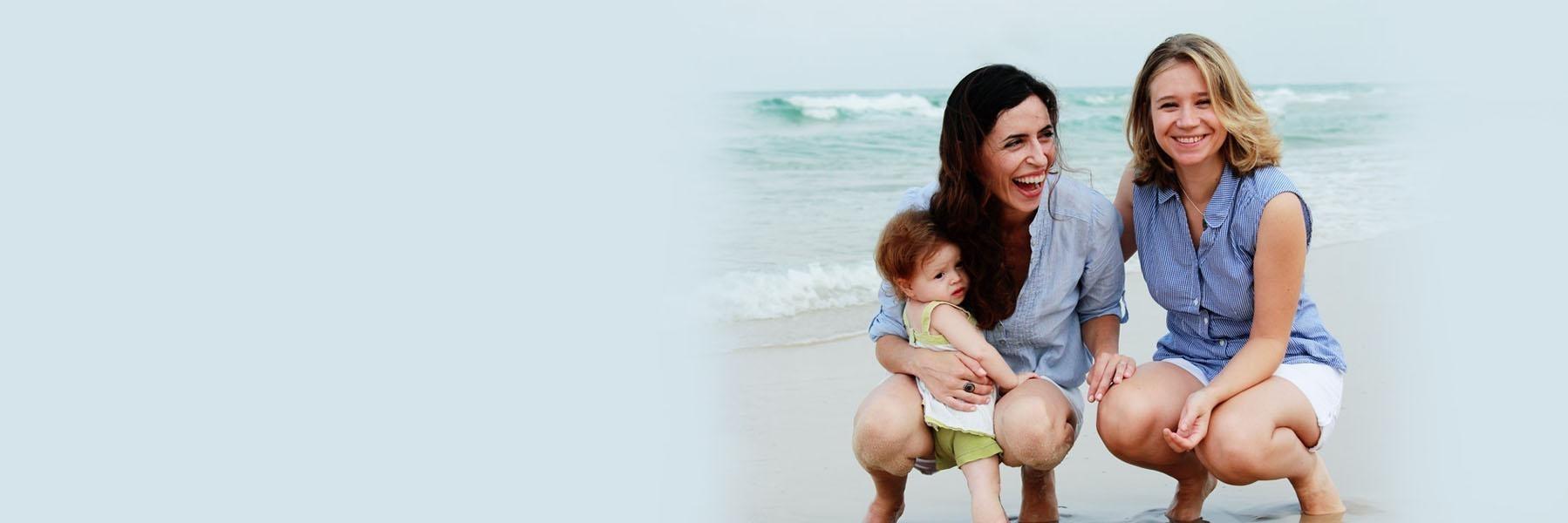 two women smiling on beach l childhood dental growth decatur il